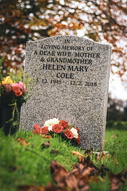 A polished gray granite gravestone with engraved lettering in memory of Helen Mary Cole, a dear wife, mother, and grandmother, dated December 12, 1945, to December 5, 2018, positioned outdoors on a lu